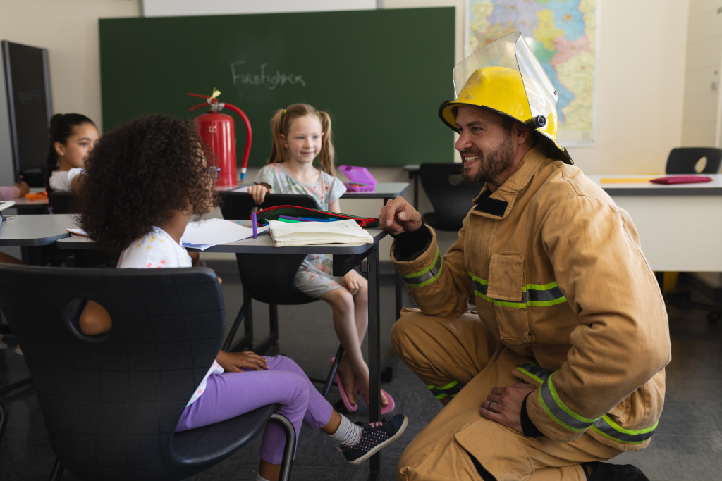 male-firefighter-teaching-schoolgirls-about-fire-s-2023-11-27-04-50-06-utc.png
